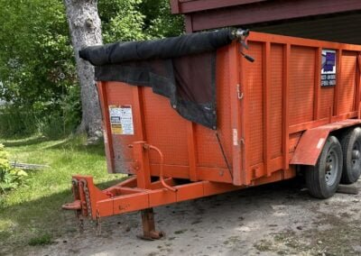 10 yard dumpster trailer parked in driveway