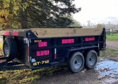 10 yard dumpster trailer parked in muddy driveway