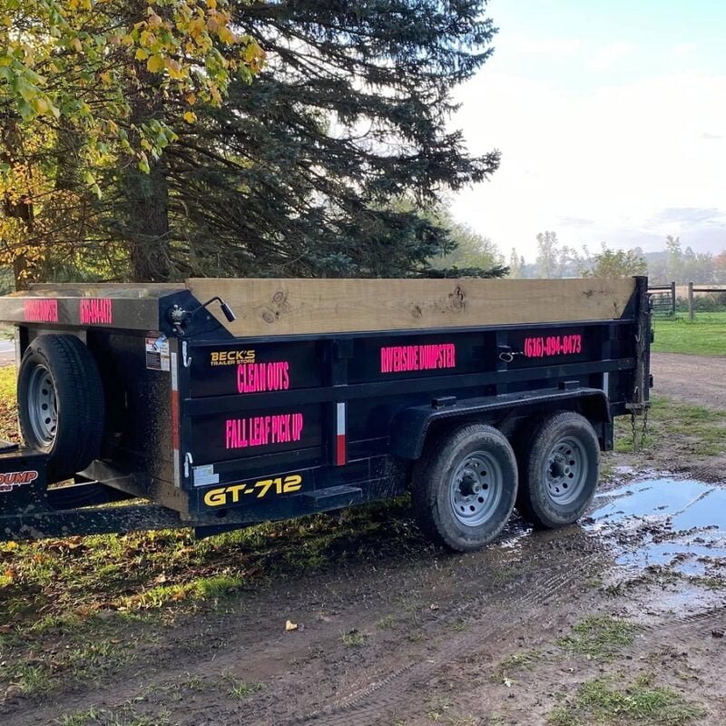 10 yard dumpster trailer parked in muddy driveway