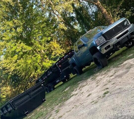 pickup truck with 15 yard roll-off dumpster on trailer, ready for delivery